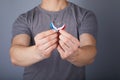 Closeup of hands holding small inconspicuous hearing aids in heart shape Royalty Free Stock Photo