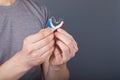 Closeup of hands holding small inconspicuous hearing aids in heart shape Royalty Free Stock Photo