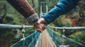 A closeup of hands holding on tightly to each other as they step forward onto a bridge with unwavering determination Royalty Free Stock Photo