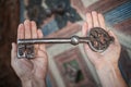 Closeup of hands holds old large huge massive metal key