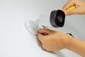 Closeup of hands installing a home security camera on a white wall Royalty Free Stock Photo