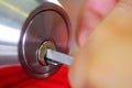 Closeup hands of locksmith using metal pick tools to open locked door Royalty Free Stock Photo
