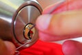 Closeup hands of locksmith using metal pick tools to open locked door Royalty Free Stock Photo