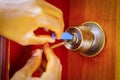 Closeup hands of locksmith using metal pick tools to open locked door Royalty Free Stock Photo