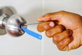 Closeup hands of locksmith using pick tools to open locked door Royalty Free Stock Photo