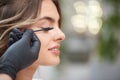 Closeup of hands of makeup artist applying mascara in salon Royalty Free Stock Photo