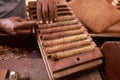 Closeup of hands making cigar from tobacco leaves. Traditional manufacture of cigars. Dominican Republic Royalty Free Stock Photo