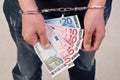 Closeup of hands man in handcuffs holding money Royalty Free Stock Photo