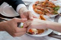 Closeup hands of man putting ring on finger of woman for marriage or engagement together with surprise at restaurant luxury.