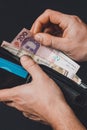 Closeup in the hands of a man`s wallet when he pulls out a 500 hryvnia banknote Royalty Free Stock Photo