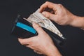 Closeup in the hands of a man`s wallet when he pulls out a 500 hryvnia banknote Royalty Free Stock Photo