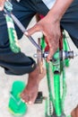 Closeup hands of a man sharpening a knife on a DIY makeshift sharpening machine on a bicycle frame Royalty Free Stock Photo