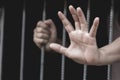 Closeup on hands of man sitting in jail, prisoner concept, Hope Royalty Free Stock Photo