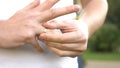 Closeup of hands. the man takes off his wedding ring standing on the street. Royalty Free Stock Photo