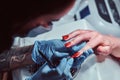 Closeup hands. Manicure procedure in progress - Beautician master applying color nail polish. Royalty Free Stock Photo