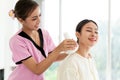 Closeup hands of a masseur holding Thai herbal compress massage on the back of a woman customer at an Asian luxury spa salon. Royalty Free Stock Photo