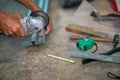 Closeup hands of the master saw the metal holding electric angle grinder working cutting aluminum lumber at construction site Royalty Free Stock Photo