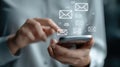 Closeup of hands navigating cloudbased mail management software on a smartphone emphasizing seamless access and realtime Royalty Free Stock Photo