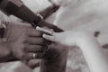 Closeup of the hands of a newly married couple wearing wedding rings - multiracial marriage Royalty Free Stock Photo