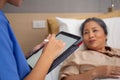 Closeup hands nurse writing report document about prescribe medical and health care on tablet while check and diagnostic.