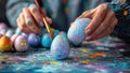 Closeup of hands painting colorful Easter eggs