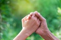 Closeup hands of people shaking up about winner on nature background 