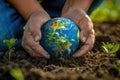 Closeup of hands planting a tree in fertile soil, a globe reflection in the background, symbolizing global sustainability , Royalty Free Stock Photo