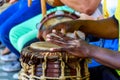 Closeup of the hands playing atabaque, a tall, wooden, Afro-Brazilian hand drum.