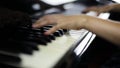 Closeup of hands playing grand piano in fast tempo