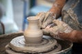 hands of potter on ceramic