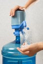 Closeup of hands pouring water into glass from bottle Royalty Free Stock Photo