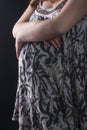 Closeup of Hands of Pregnant Woman posing Againt Black