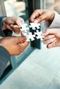 Closeup, hands and puzzle with collaboration, group and teamwork with partnership, planning and brainstorming. Zoom Royalty Free Stock Photo