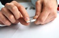 Closeup of hands removing shield from the single professional coaxial cable connector. Royalty Free Stock Photo