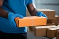 Closeup hands in rubber gloves handle cardboard boxes for fast online shopping delivery