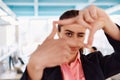 Closeup of hands, Smiling Business Woman Making Frame Gesture with at modern bright coworking open space startup office Royalty Free Stock Photo