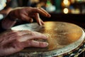 closeup of hands tapping a beat on an irish drum in the pub