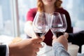 Closeup hands of team young business people in party celebrate success holding glass of wine cheer together at restaurant luxury. Royalty Free Stock Photo