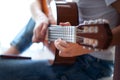 Closeup of hands teenager playing acoustic guitar. Have a hobby. Relaxing boy playing guitar