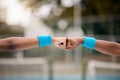 Closeup on the hands of tennis players on the court. Two tennis players give each other a fist bump. Friends motivate Royalty Free Stock Photo