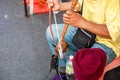 Closeup hands of Thai street musician playing Thai fiddle at Chiang mai walking street.