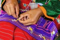Thailander Hill tribe ladies are demonstrating the sewing and decorating of costumes for tourists Royalty Free Stock Photo