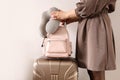 Closeup hands of travel woman holding backpack and stylish suitcase ready to business trip vacation Royalty Free Stock Photo