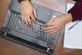 Closeup on Hands Typing on Keyboard, Notebook and Pen Royalty Free Stock Photo