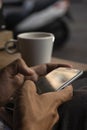 Closeup of a hands using a mobile in a cafe Royalty Free Stock Photo