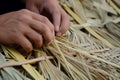 closeup of hands weaving straw into thatched roof Royalty Free Stock Photo