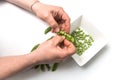 Hands of woman peeling fresh organic peas on white table background Royalty Free Stock Photo