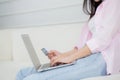 Closeup hands of woman sitting on sofa using laptop computer online shopping with credit card. Royalty Free Stock Photo