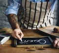 Closeup of hands writing open word on chalkboard