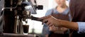 Closeup hands of young asian woman holding coffee grinder powder while mashed for preparing making coffee. Royalty Free Stock Photo